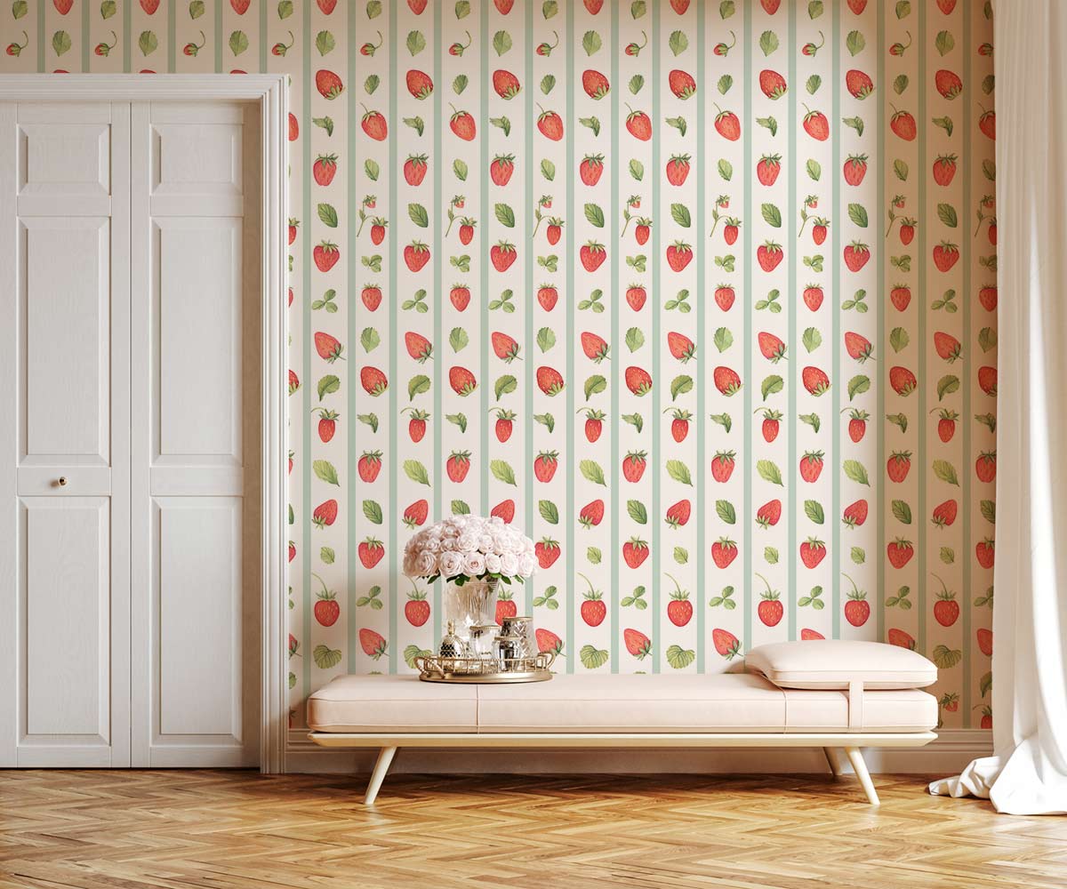Charming strawberry and leaf wallpaper in pastels; features soft pink sofa, wooden flooring, white doors.