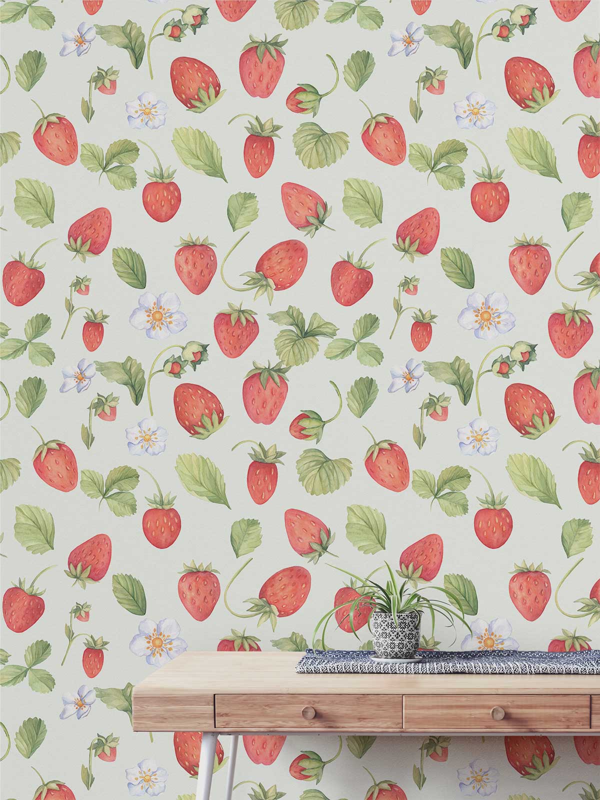 Charming Strawberry Field wallpaper, watercolour pattern, red and green; light wood table, contemporary decor.