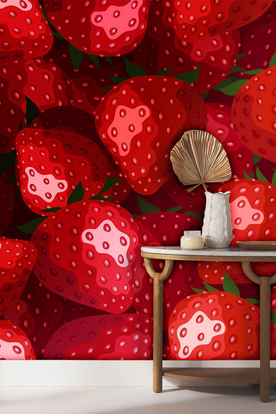 Vibrant red strawberry wallpaper in retro kitchen Décor, complemented by gold-framed table and white base.