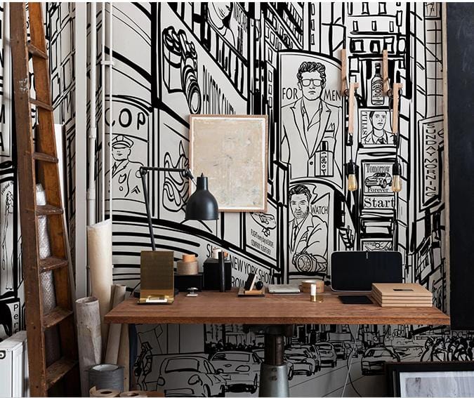 Monochrome urban mural, modern street scene, wooden desk, industrial lighting, ladder, framed artwork.