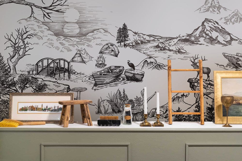 Vintage monochrome nature mural wallpaper featuring rustic wildlife, framed art, candle holders; green sideboard.