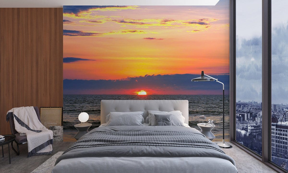 Tranquil Ocean Sunset Mural with grey bed, wood-panelled wall, large windows, and modern floor lamp.