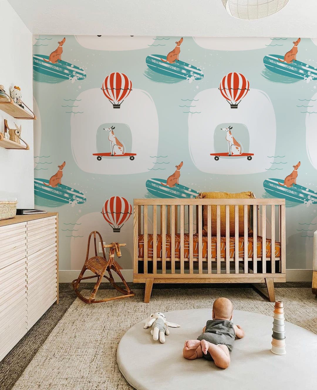 Whimsical Sky Adventure wallpaper in nursery with wooden cot, soft teal, playful Australian animal design.