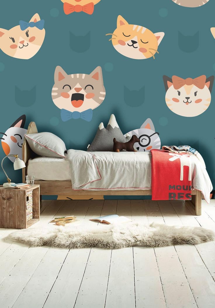 Charming Cat Faces Teal Kids' Wallpaper in bedroom with wooden bed, plush toys, and light flooring.
