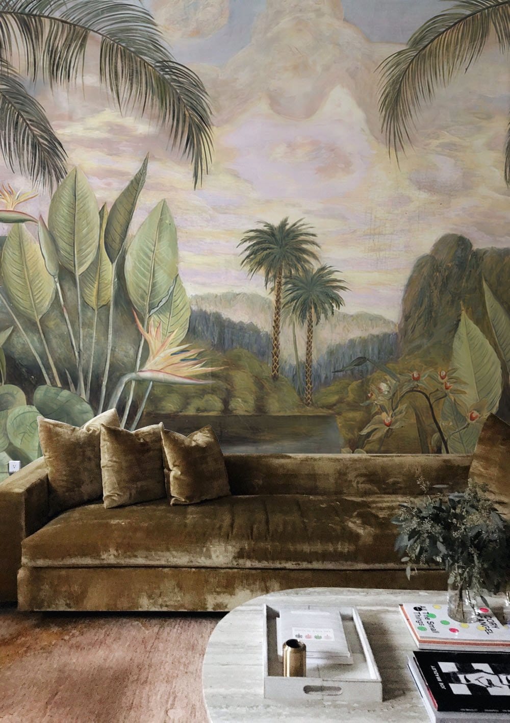 Tropical Paradise Jungle Mural with green velvet sofa, neutral rug, coffee table in living room.