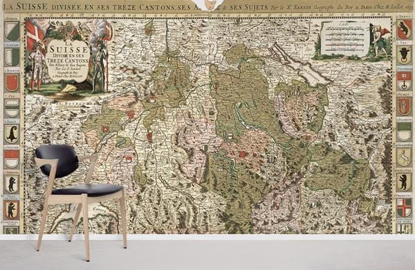 Vintage Swiss Map Mural Wallpaper in earthy tones, featuring chair, grey floor, positioned in living room.