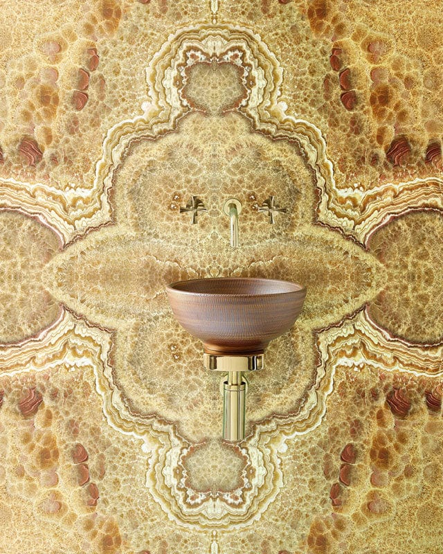 Vintage marble effect wallpaper with ornate pattern, featuring a modern brass tap and ceramic basin.