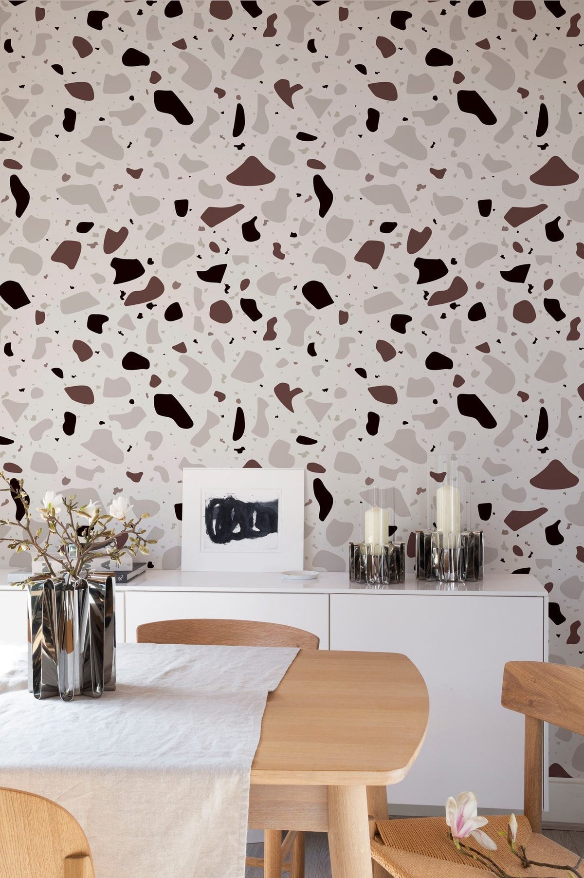 Modern Chic Terrazzo Wallpaper in dining room, neutral tones, wooden table, white sideboard, stylish decor.
