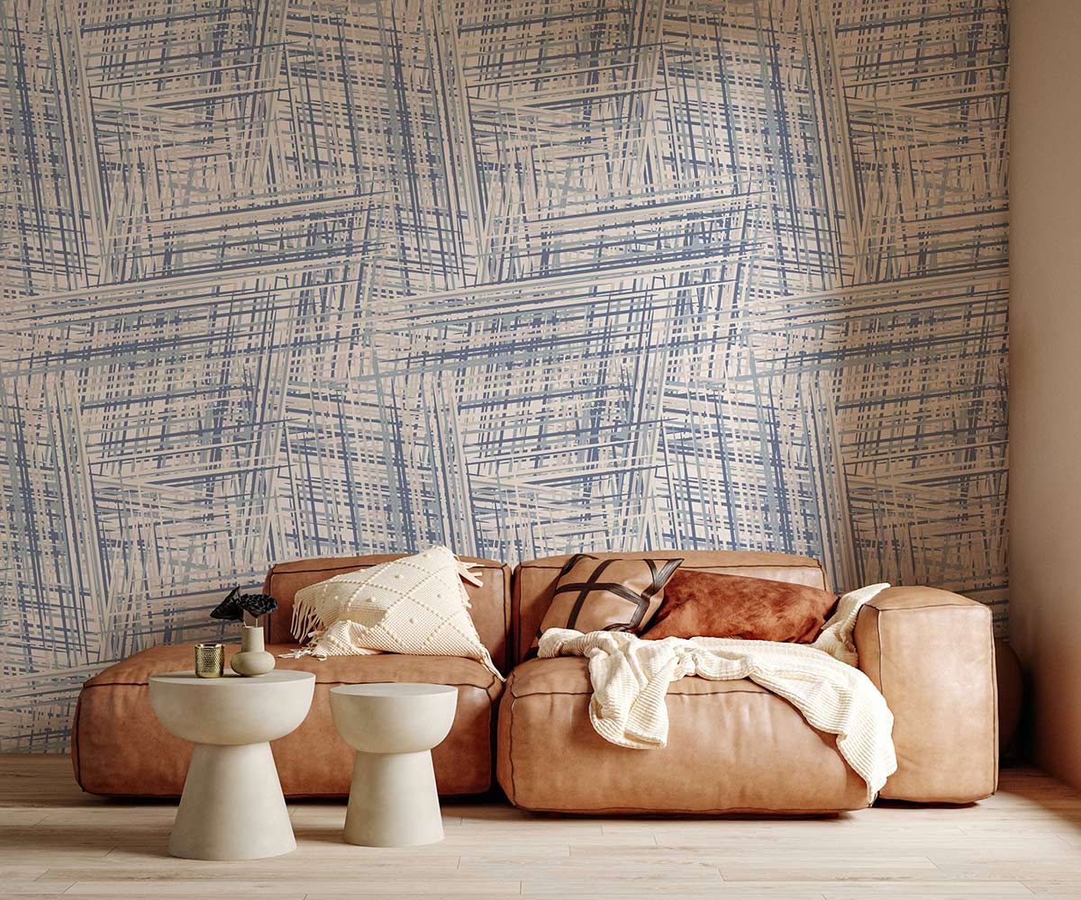 Vintage blue geometric wallpaper with tan sofa, modern tables, and light wood flooring in living room.