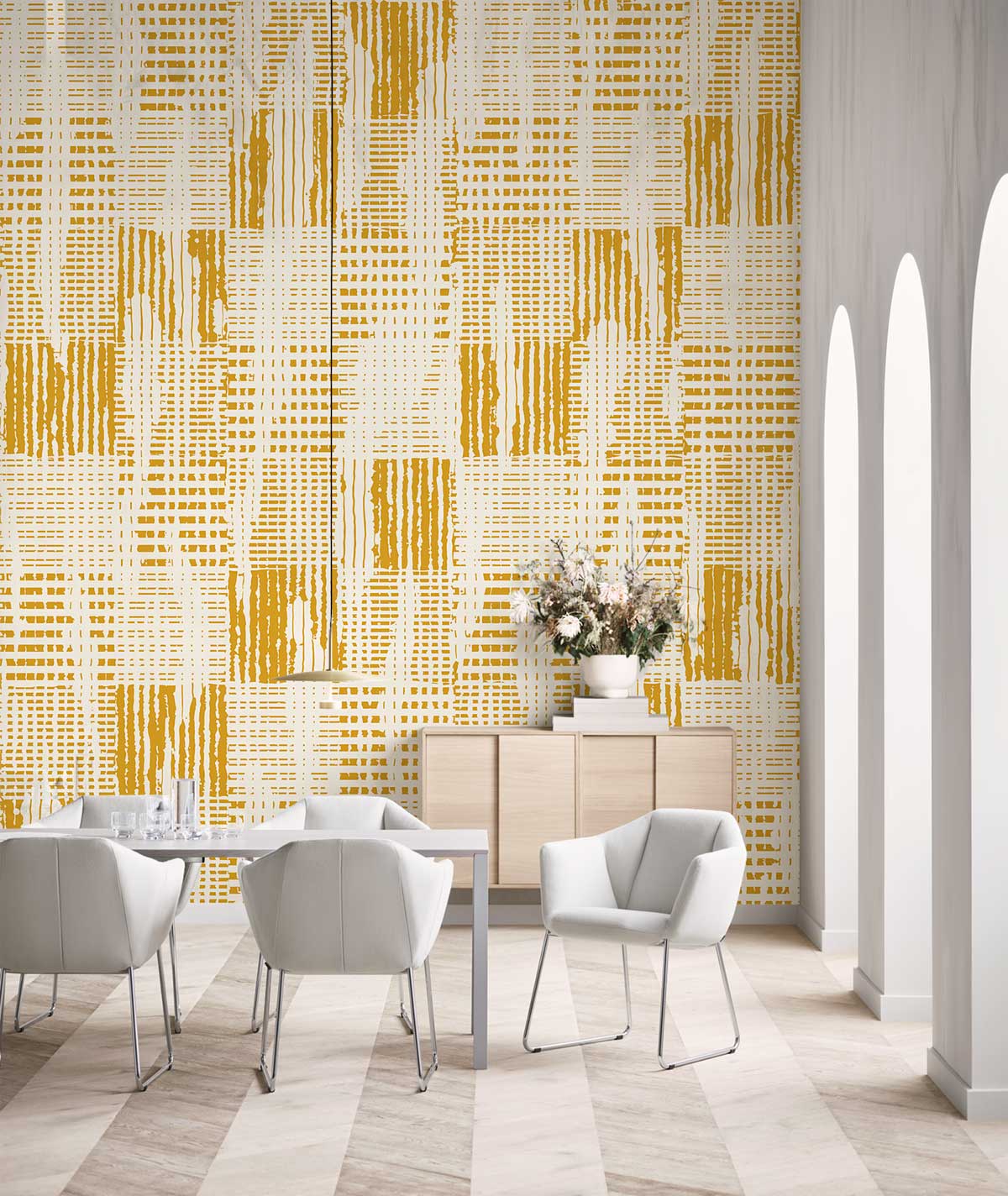 Vintage mustard geometric wallpaper in modern dining room with white chairs, light wood flooring, sideboard.