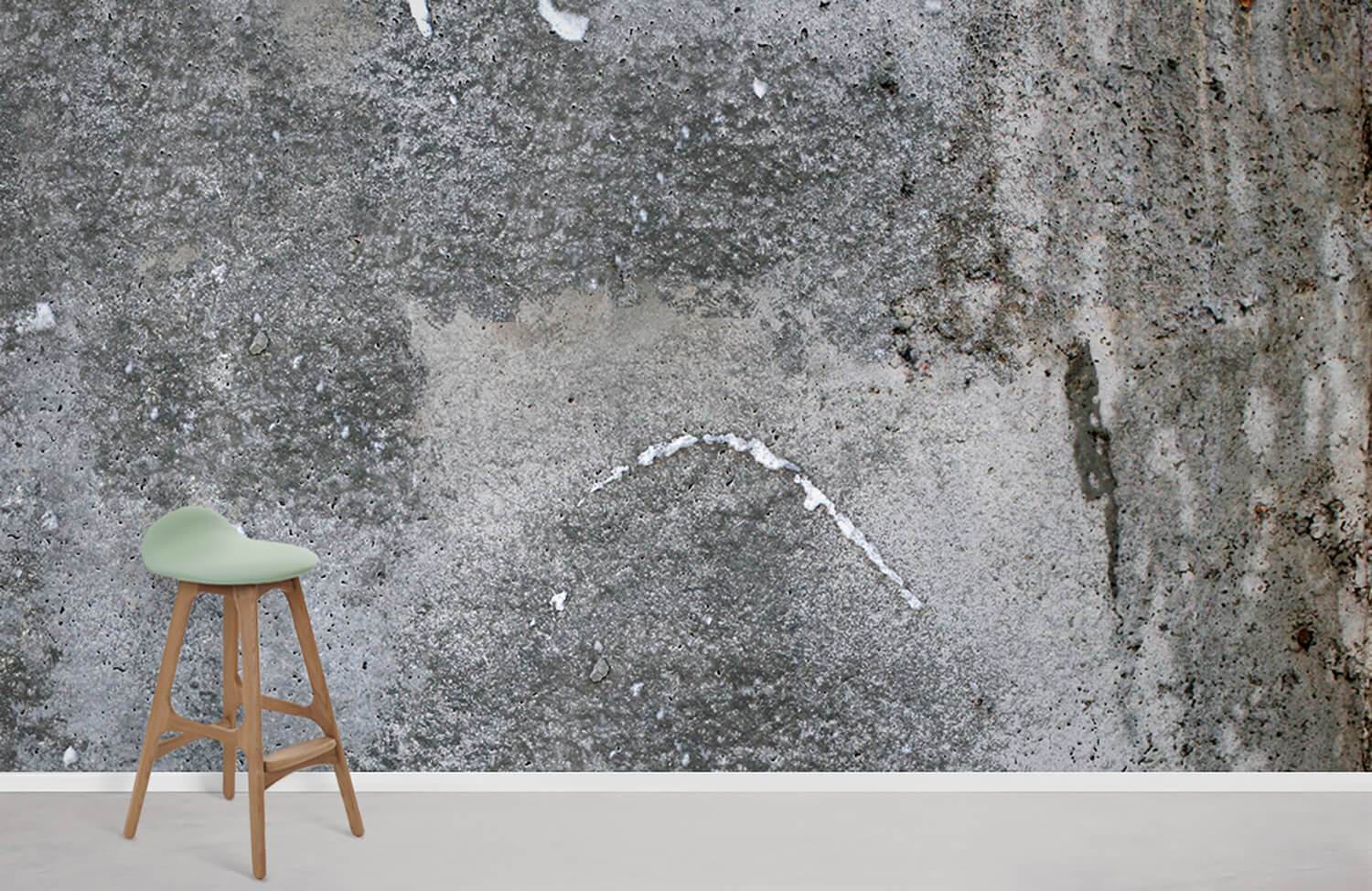 Industrial grey concrete effect wallpaper with modern mint green stool on beige flooring in minimalist room.