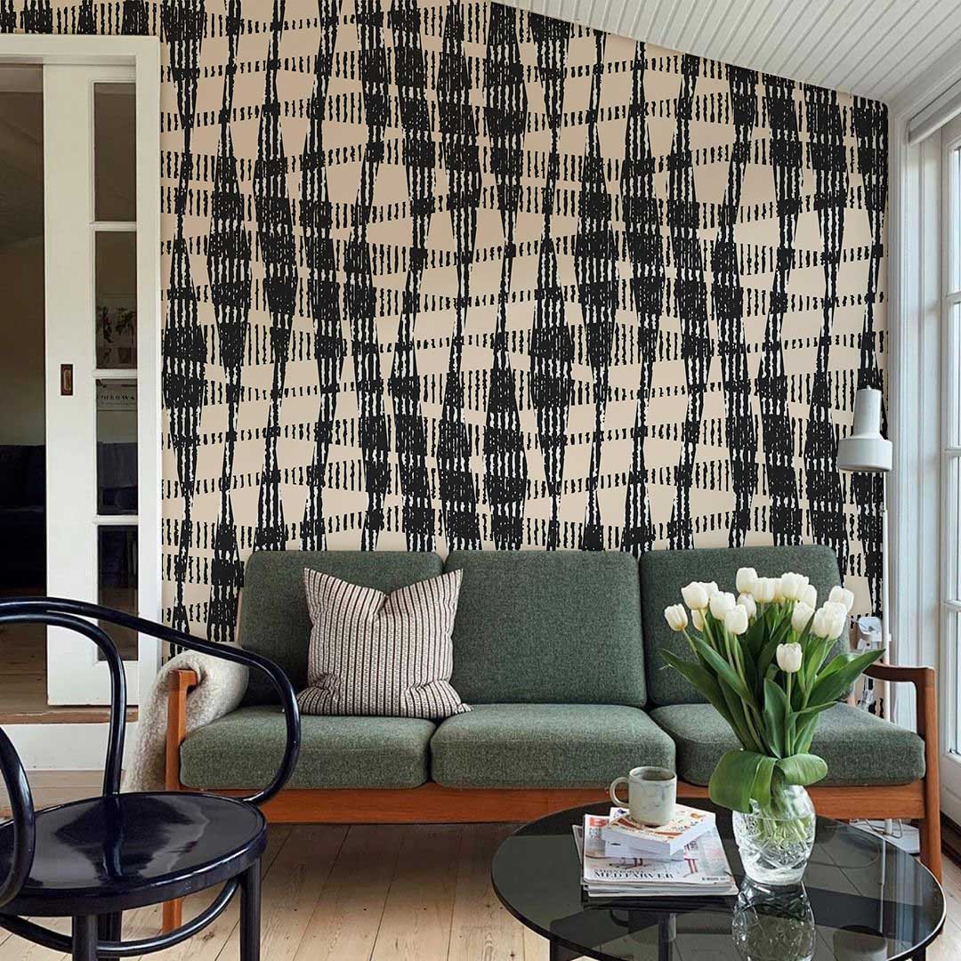 Modern geometric wallpaper with green sofa, light wood flooring, and contemporary decor in stylish interior.