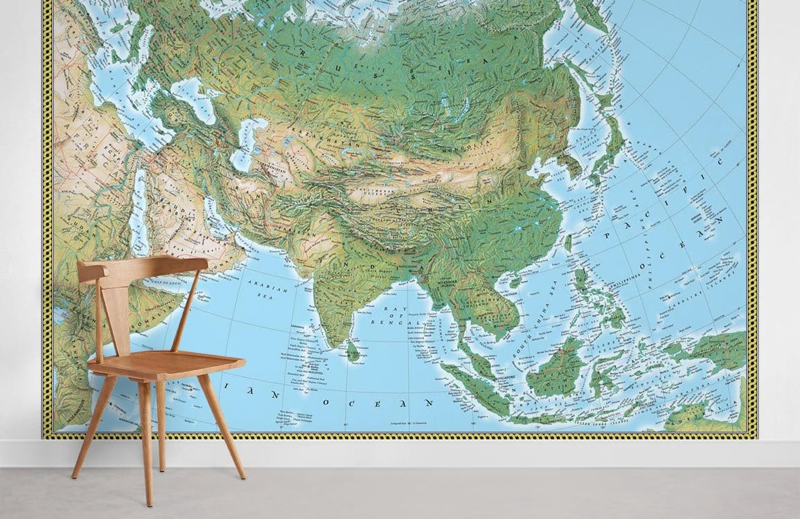 Asia Vintage Physical Map Mural Wallpaper with green-blue tones, wooden chair, light grey flooring.