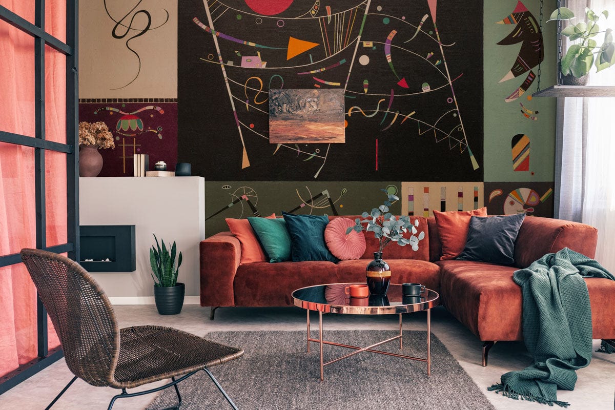 Abstract geometric wallpaper in dynamic living room, featuring brown sofa, grey rug, modern decor.