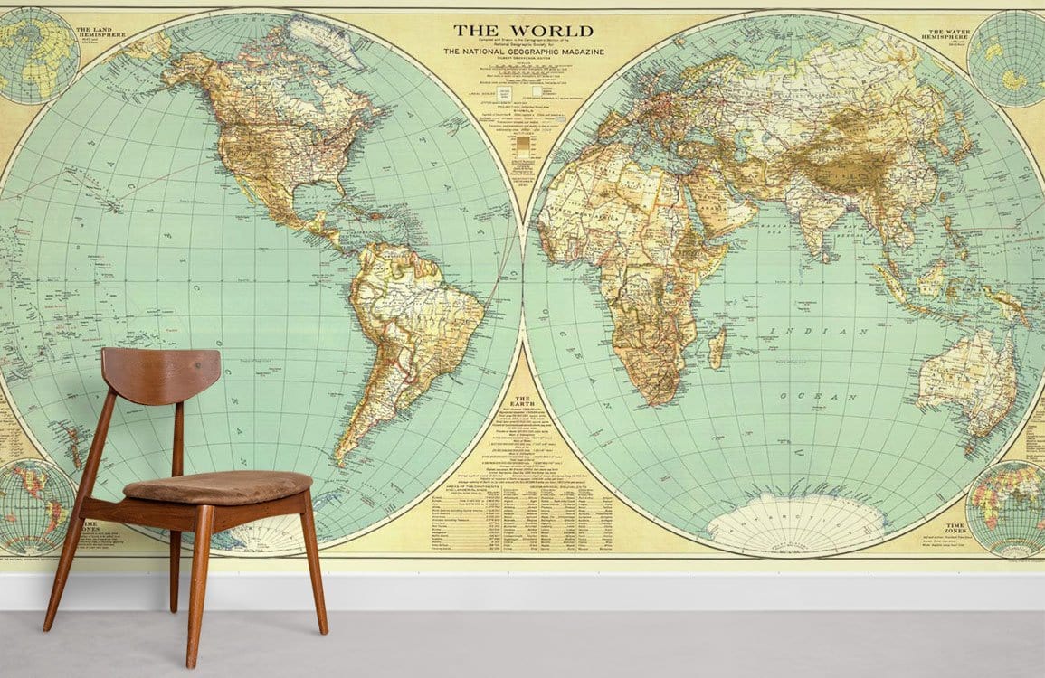 Vintage world map mural wallpaper in earthy tones, with wooden chair on grey flooring in living room.