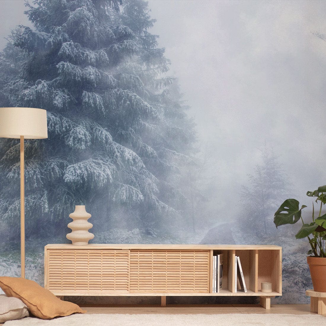 Mystical Winter Wonderland wallpaper with frosted trees; light wooden furniture; cosy living room setting.