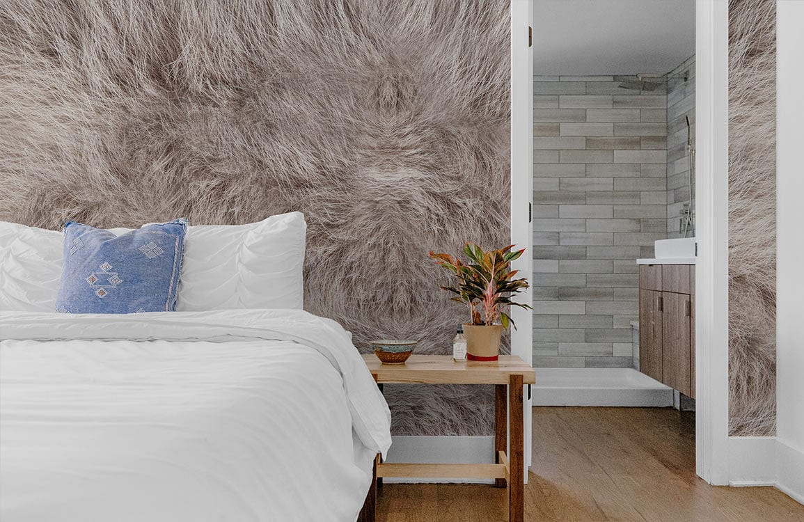 Luxurious grey faux fur wallpaper in cosy bedroom with white bed, wooden flooring, and modern bathroom.