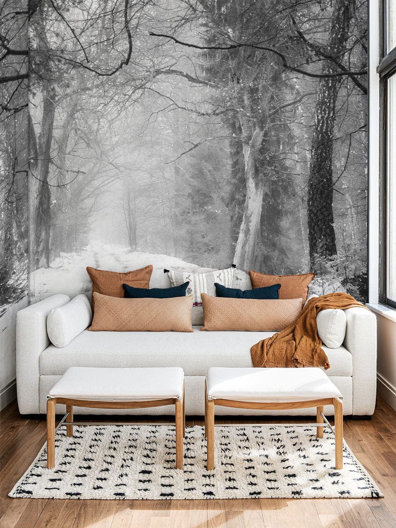 Enchanting Winter Forest Path Black White Mural Wallpaper, cosy sofa, stylish cushions, wooden flooring.