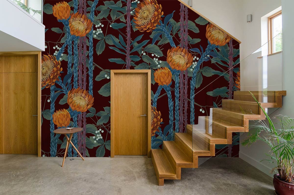 Luxurious botanical floral wallpaper with maroon blooms in modern hallway, wood stairs, concrete flooring.
