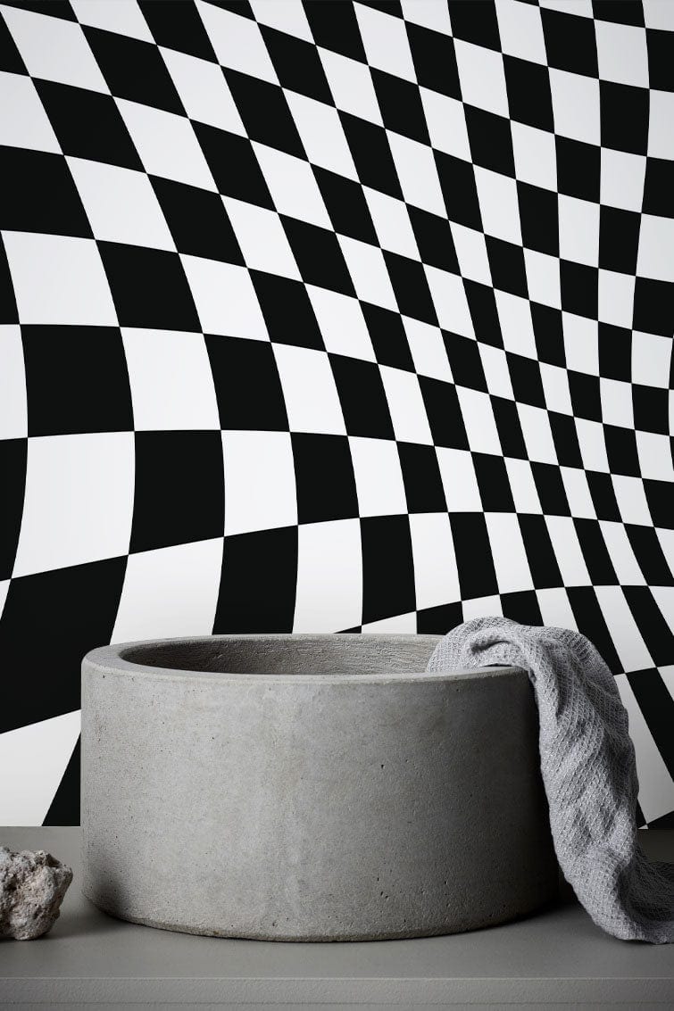 Monochrome checkered optical illusion wallpaper behind concrete tub, modern bathroom interior design.