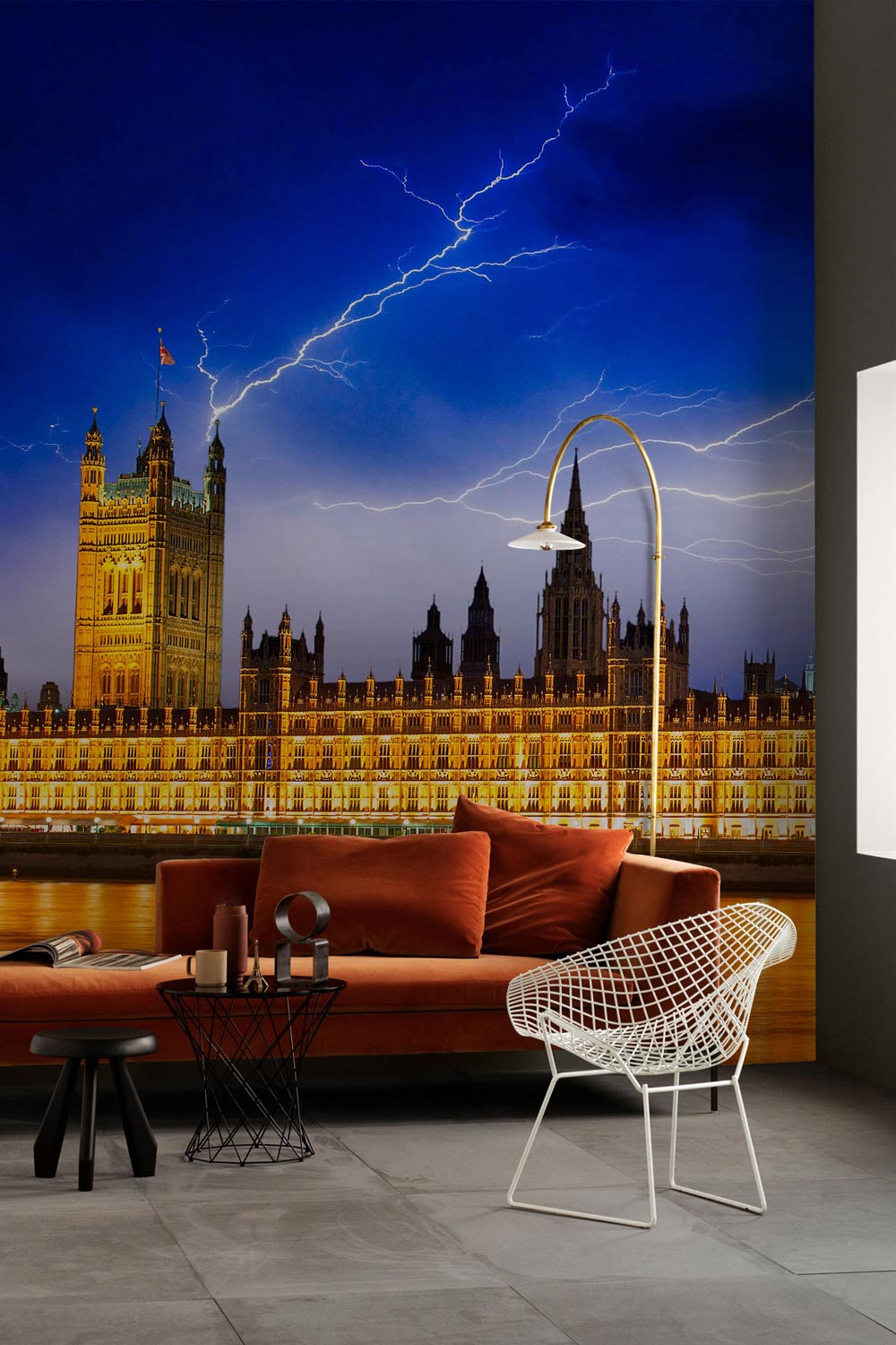 Majestic wallpaper with London skyline, lightning; features brown sofa, modern chair, grey floor.