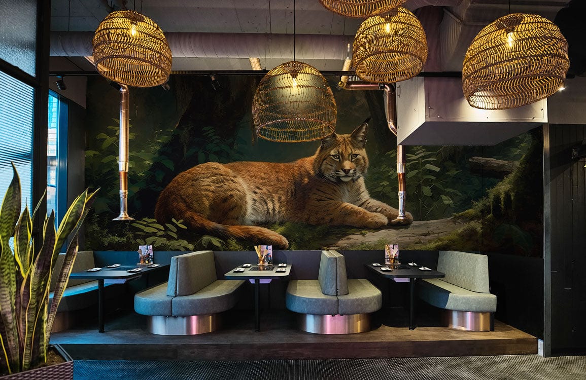 Majestic Lynx Forest Scene mural wallpaper in earthy tones, modern restaurant with wicker lamps.