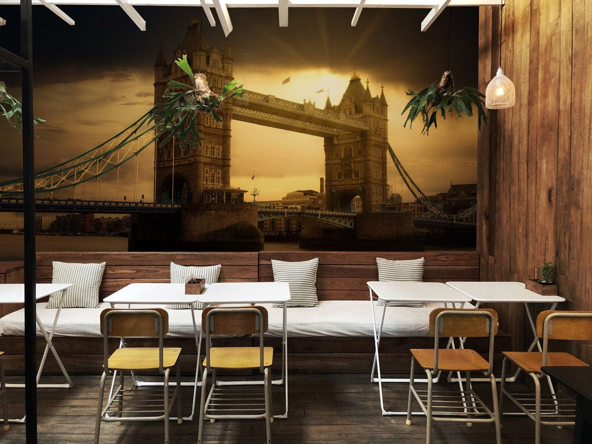 Vintage Sunset London Bridge mural wallpaper with warm tones, wood walls, cafe tables, and chairs.