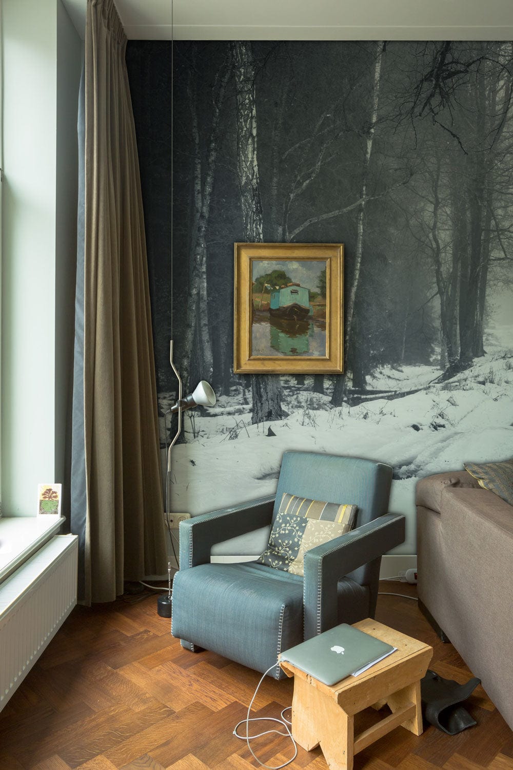 Enchanting Winter Forest Path Wallpaper in living room with cosy armchair, wooden flooring, elegant decor.
