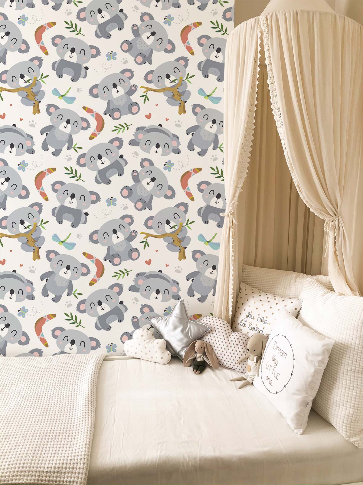 Children's room with koala pattern wallpaper, white canopy bed, neutral decor, and playful theme.
