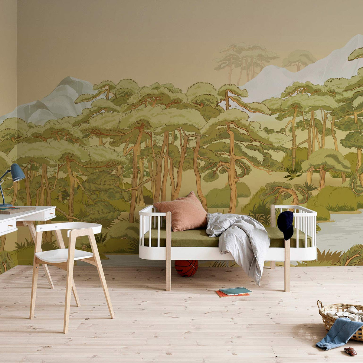 Tranquil green forest mural wallpaper in child's room, light wood flooring, modern white bed, desk.