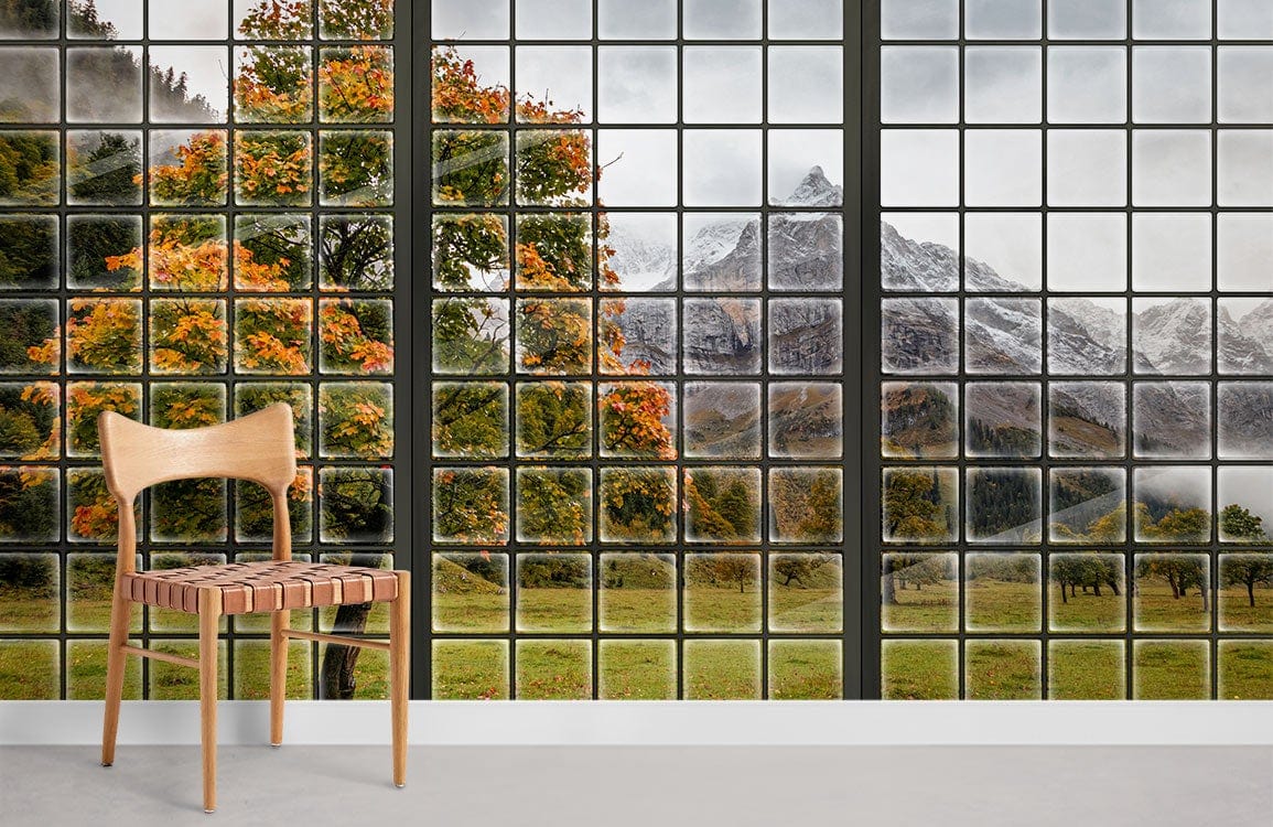 Scenic Mountain Autumn View Window Mural Wallpaper in living room with wooden chair and grey flooring.