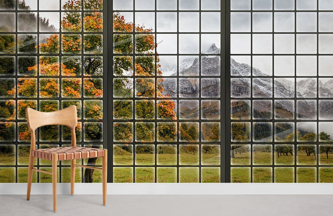 Scenic Mountain Autumn View Window Mural Wallpaper in living room with wooden chair and grey flooring.