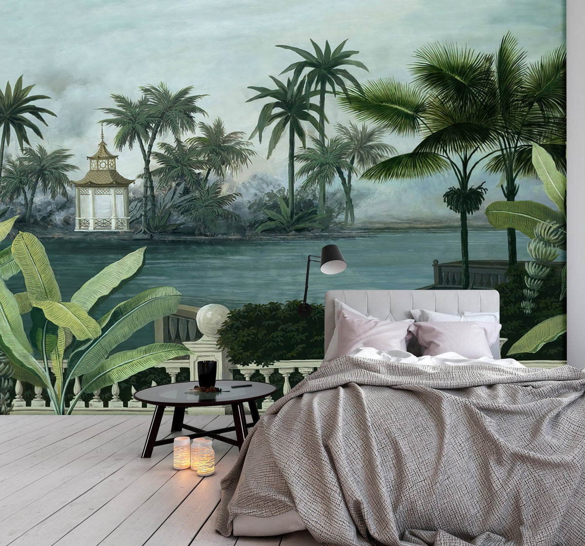 Bedroom with Serene Tropical Oasis mural, palm design, grey sofa, light wood flooring, ambient lighting.