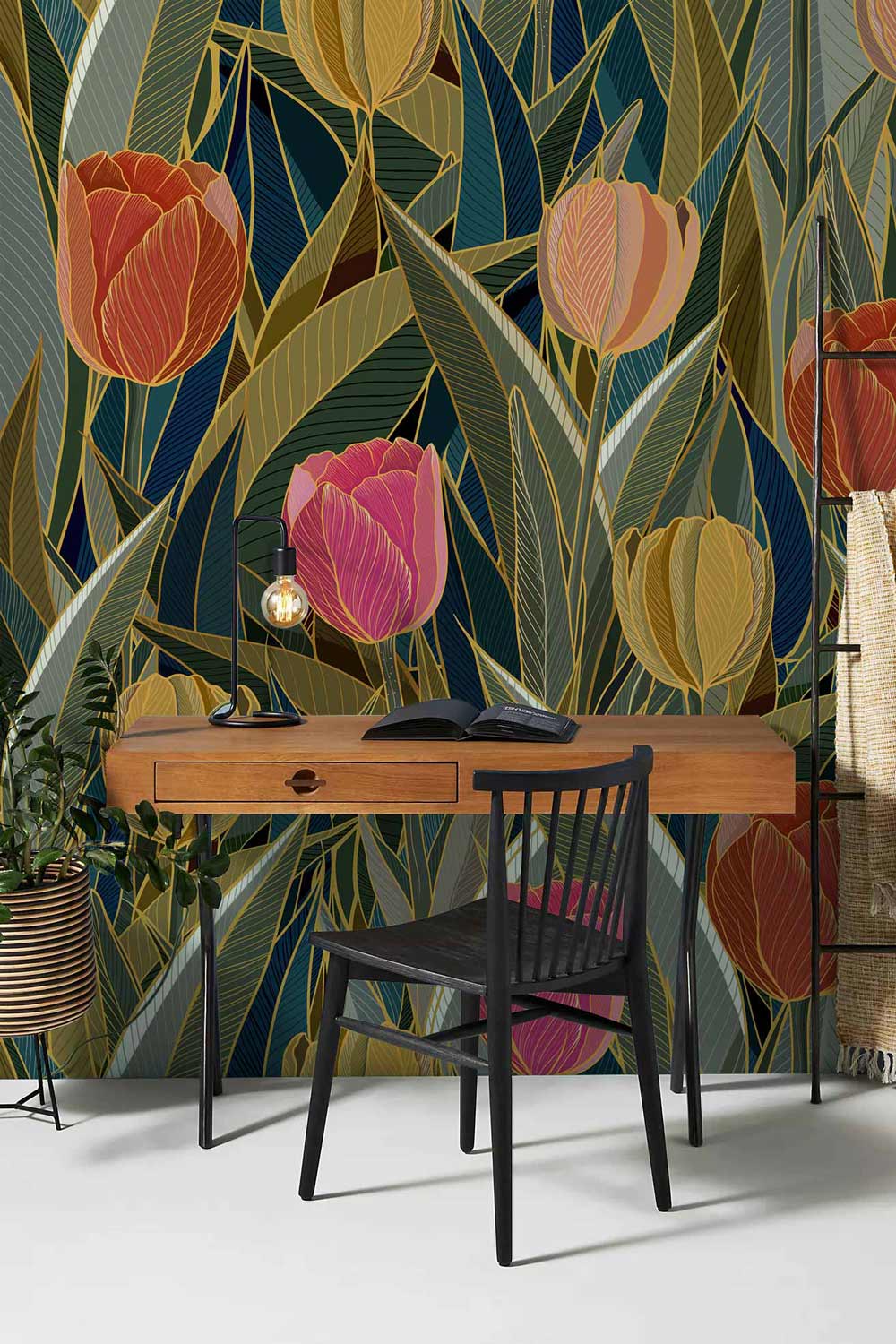 Vintage floral tulip wallpaper; vibrant earthy tones; wooden desk; black chair; creative workspace setting.
