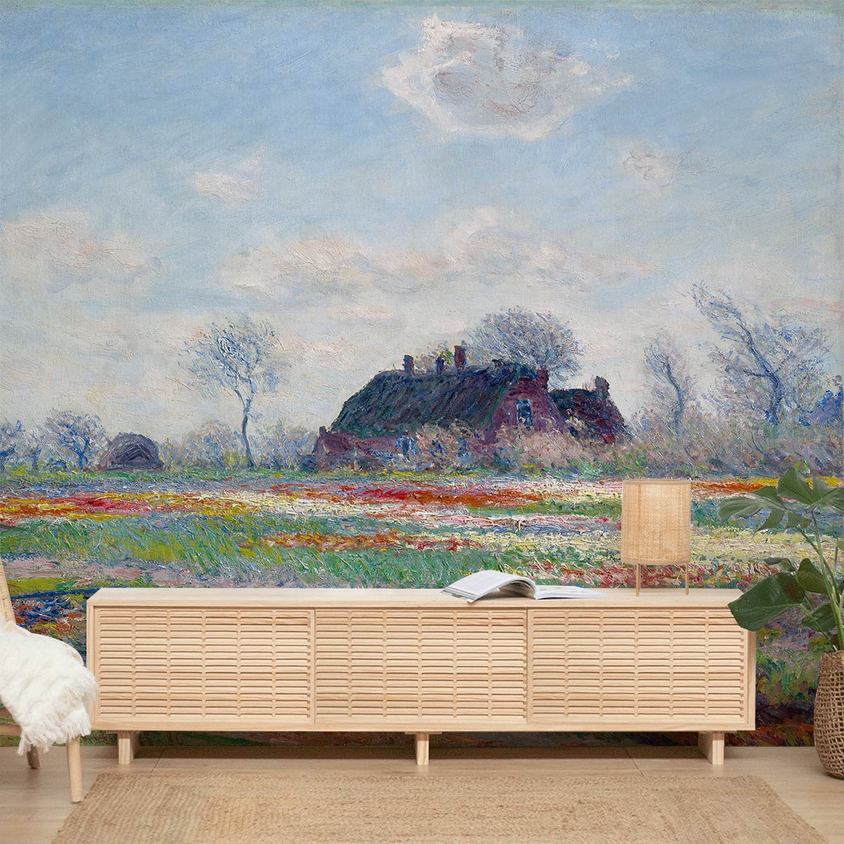 Impressionist landscape mural in pastel room with light wood cabinet, soft armchair, and lamp.