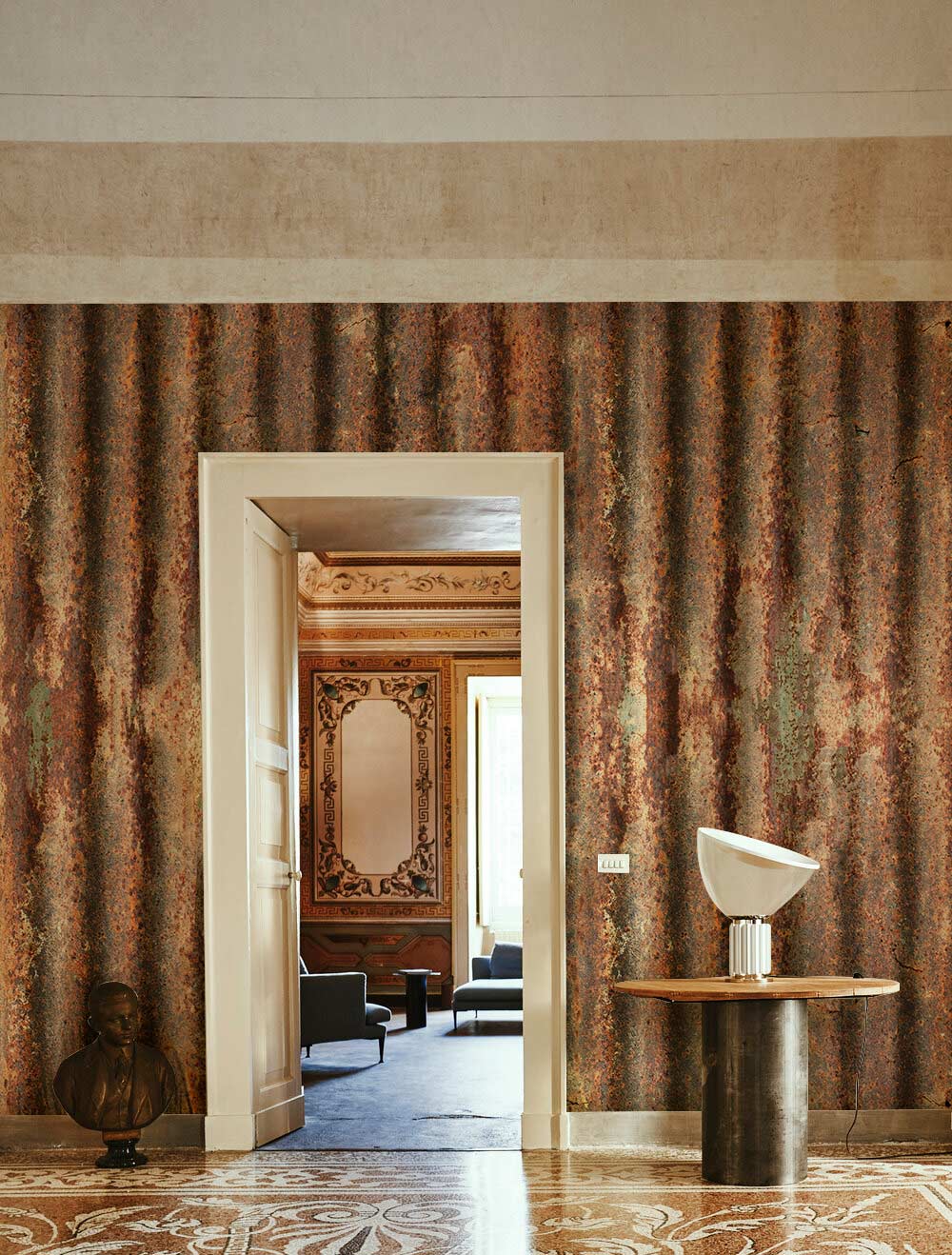 Vintage corrugated iron rust-effect wallpaper in rustic room with patterned flooring and modern decor.