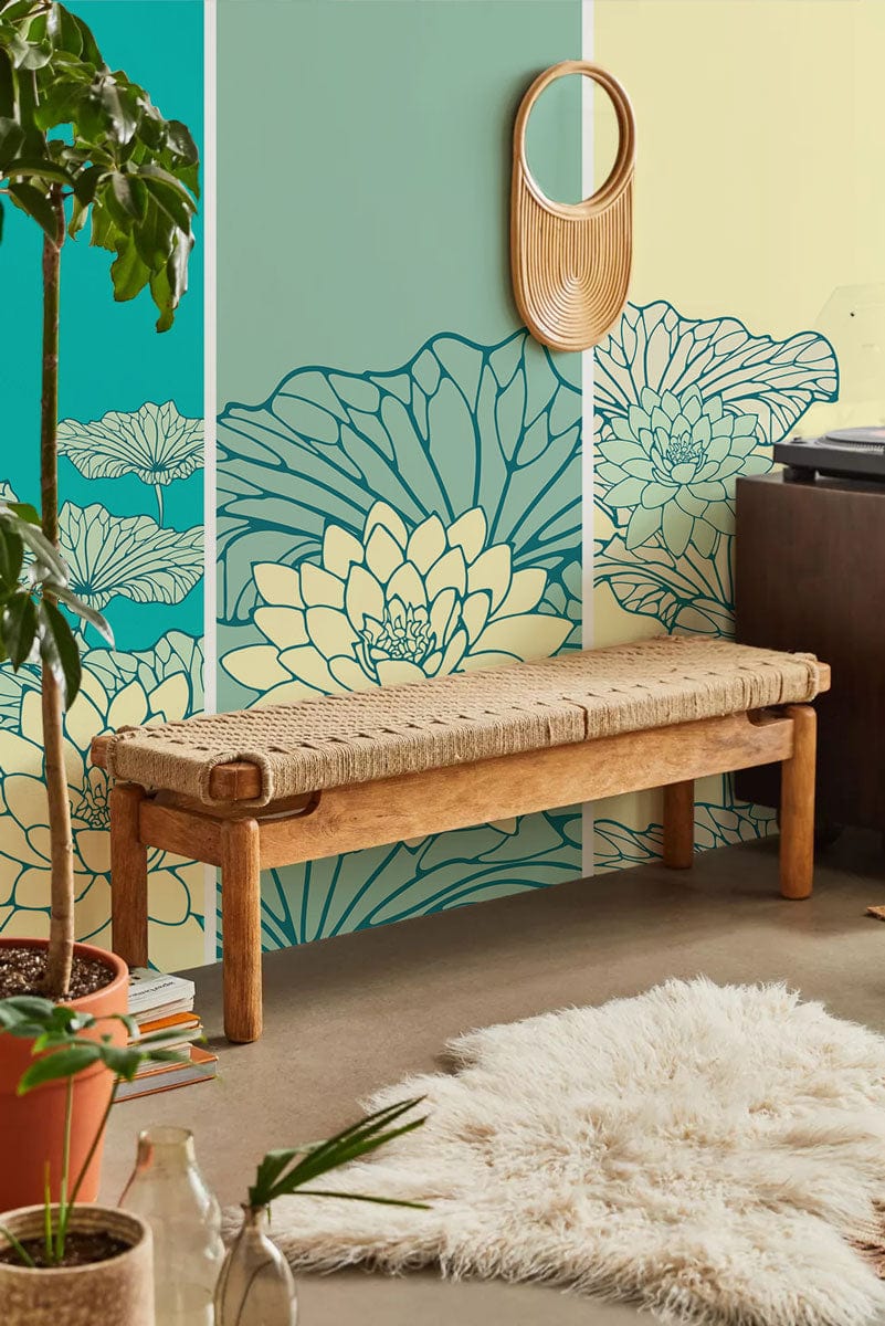 Elegant teal and yellow lotus floral mural wallpaper in contemporary room with wooden bench and rug.
