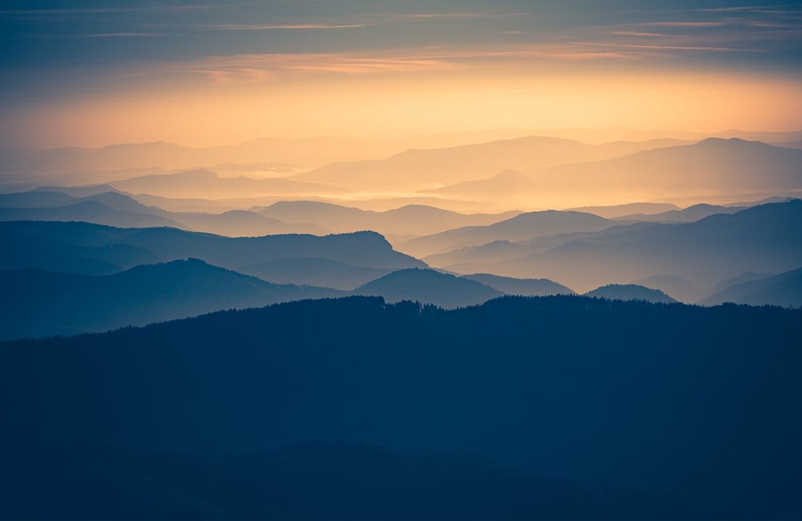 Tranquil Misty Mountains at Dusk Landscape Mural Wallpaper - Serene Blue Hues