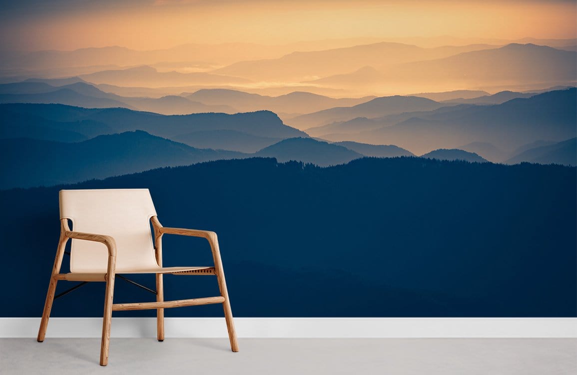 Tranquil Misty Mountains wallpaper in serene blue with beige chair on white floor in modern room.