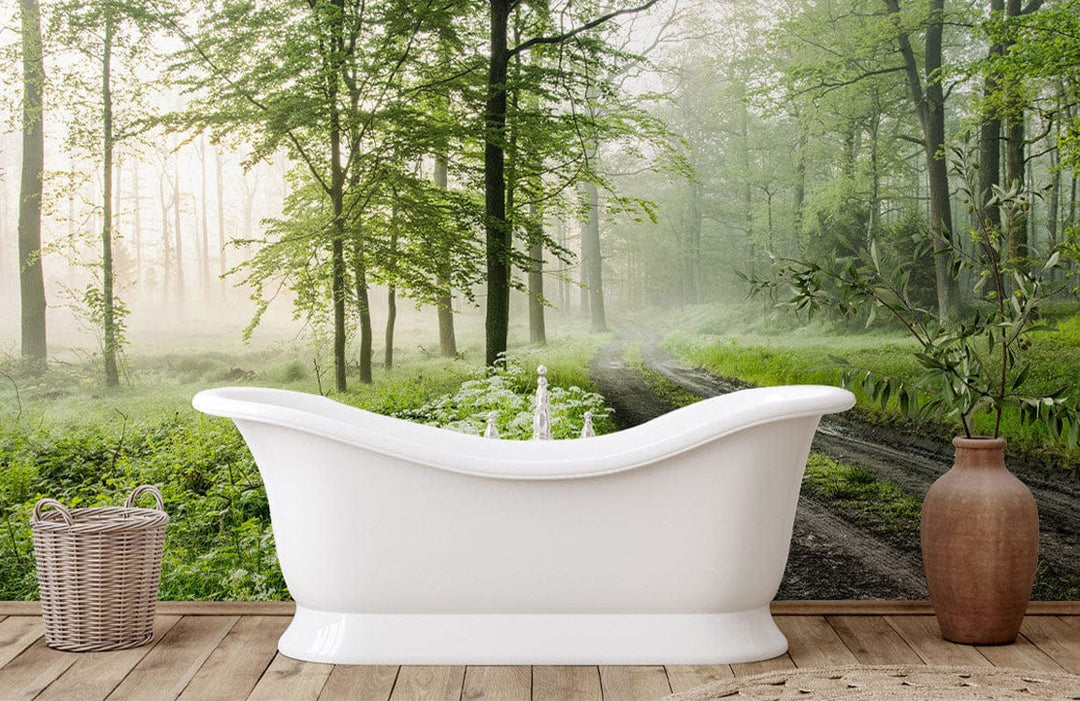 Tranquil Misty Forest Path Mural Wallpaper in bathroom, featuring white bathtub, wooden flooring, vase.