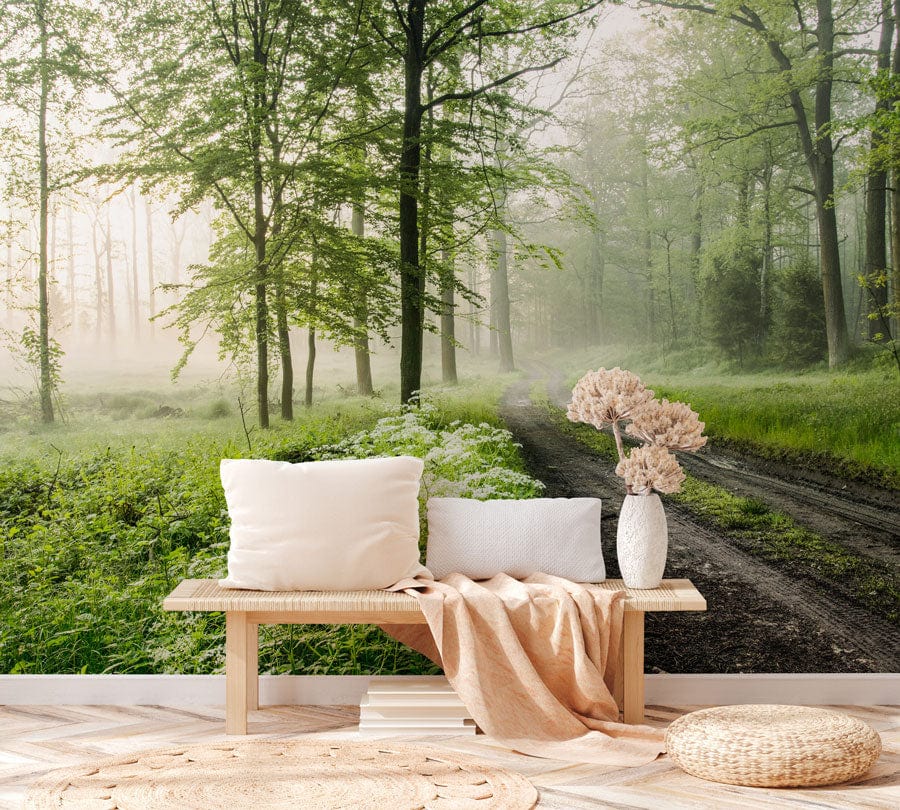 Tranquil Misty Forest Path Green Nature Mural Wallpaper in living room with wooden bench and cushions.