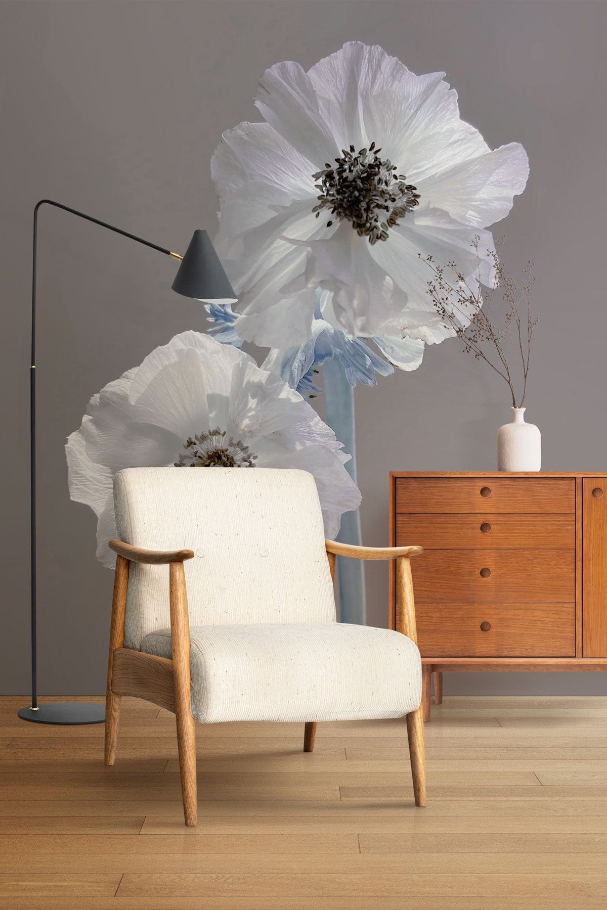 Silent Whisper floral mural wallpaper, beige armchair, wooden floor, mid-century cabinet, floor lamp.