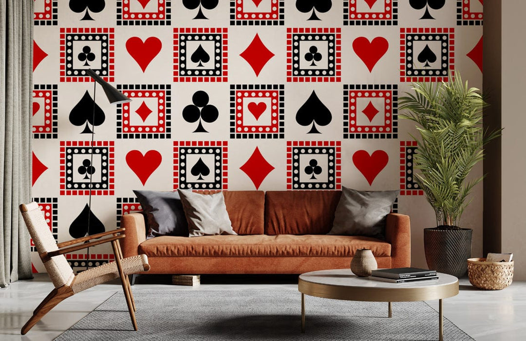Retro pattern wallpaper featuring poker hearts and spades, with modern brown sofa, grey rug, and plant.