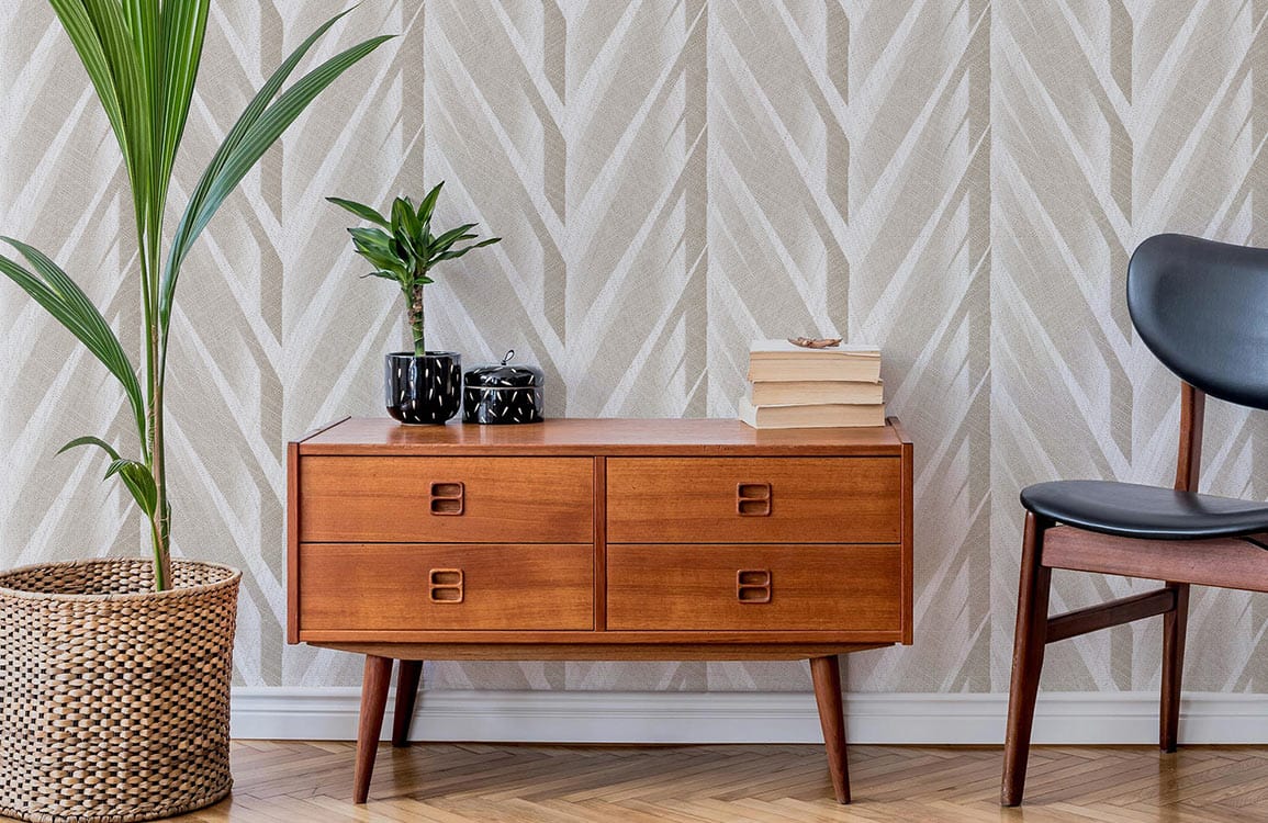 Elegant Chevron wallpaper in neutral tones, wooden sideboard, potted plant, black chair, herringbone flooring.