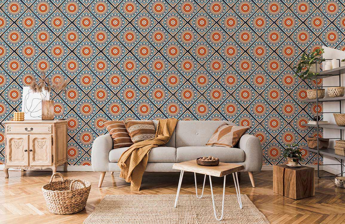 Cosy living room with Moroccan geometric blue-orange wallpaper, grey sofa, vintage cabinet, chevron flooring.