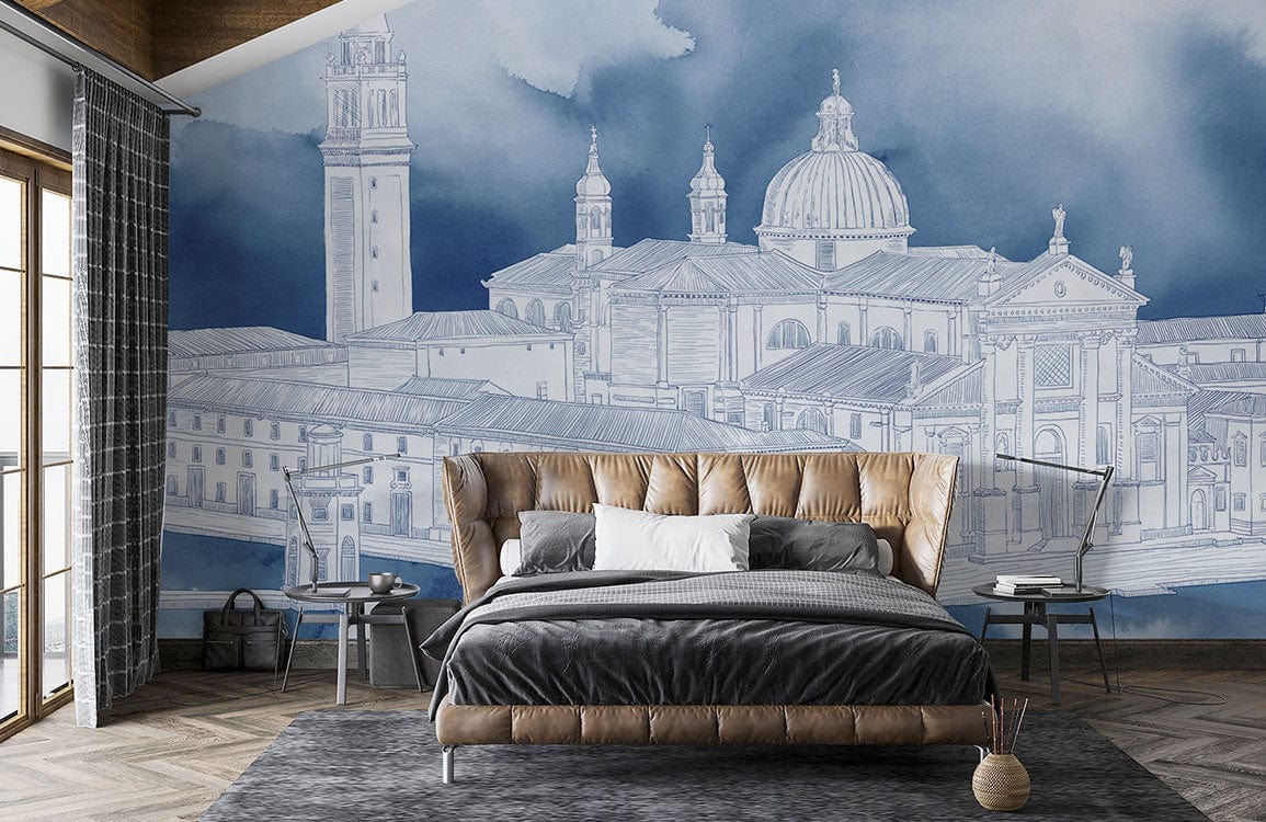 Elegant blue watercolour Venice mural wallpaper in modern bedroom with tan leather bed, grey rug, parquet flooring.