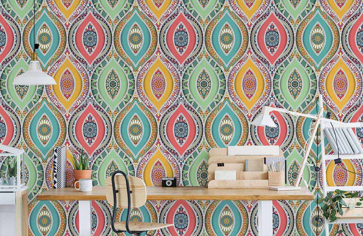 Vibrant multicoloured bohemian wallpaper with geometric pattern, stylish wooden desk, black chair, home office.