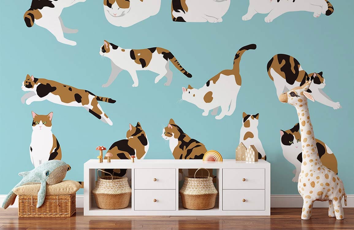 Charming Calico Cats wallpaper in nursery with white dresser, wooden flooring, plush giraffe decoration.
