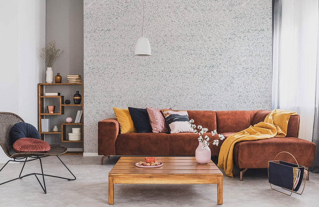 Elegant soft white textured wallpaper, brown sofa, wooden furniture, modern living room, grey flooring.