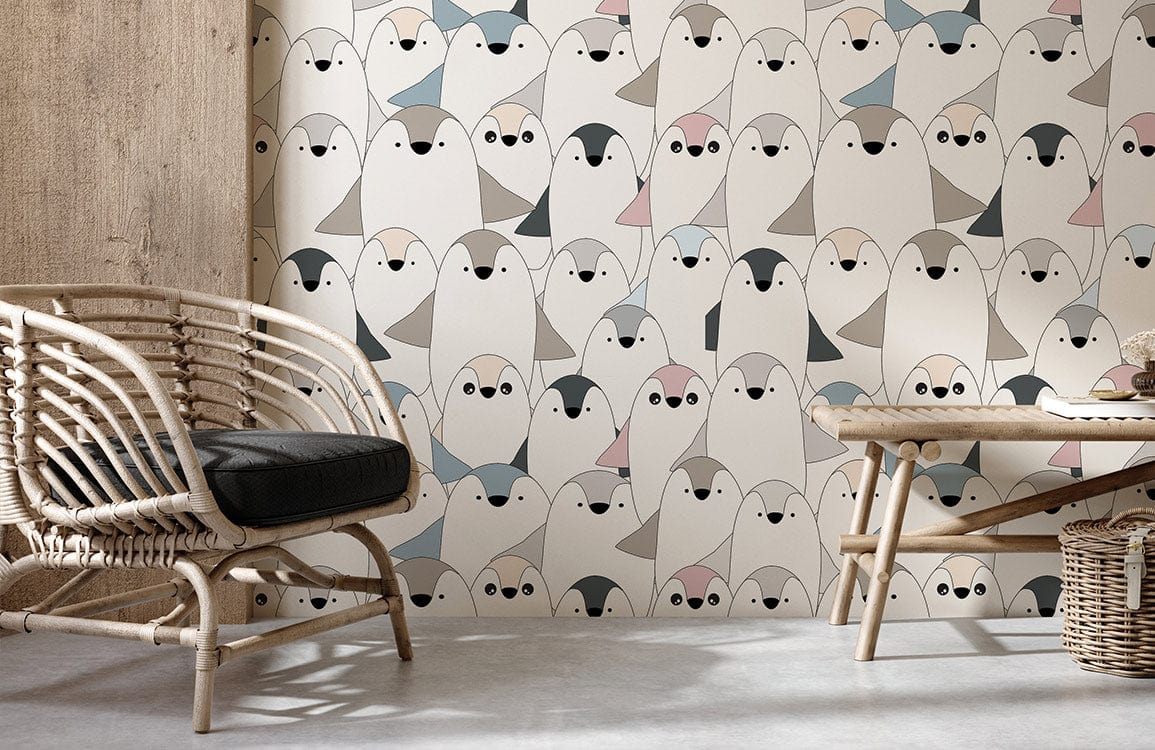 Adorable pastel penguin wallpaper in modern nursery with rattan chair, concrete floor, and wooden accents.